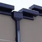 Dark brown gutter downspout and miter