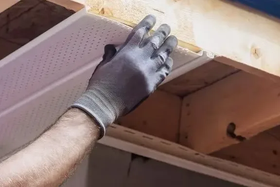 Soffit panel being installed on wood framing
