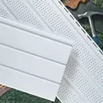Stack of white vented vinyl soffit panels